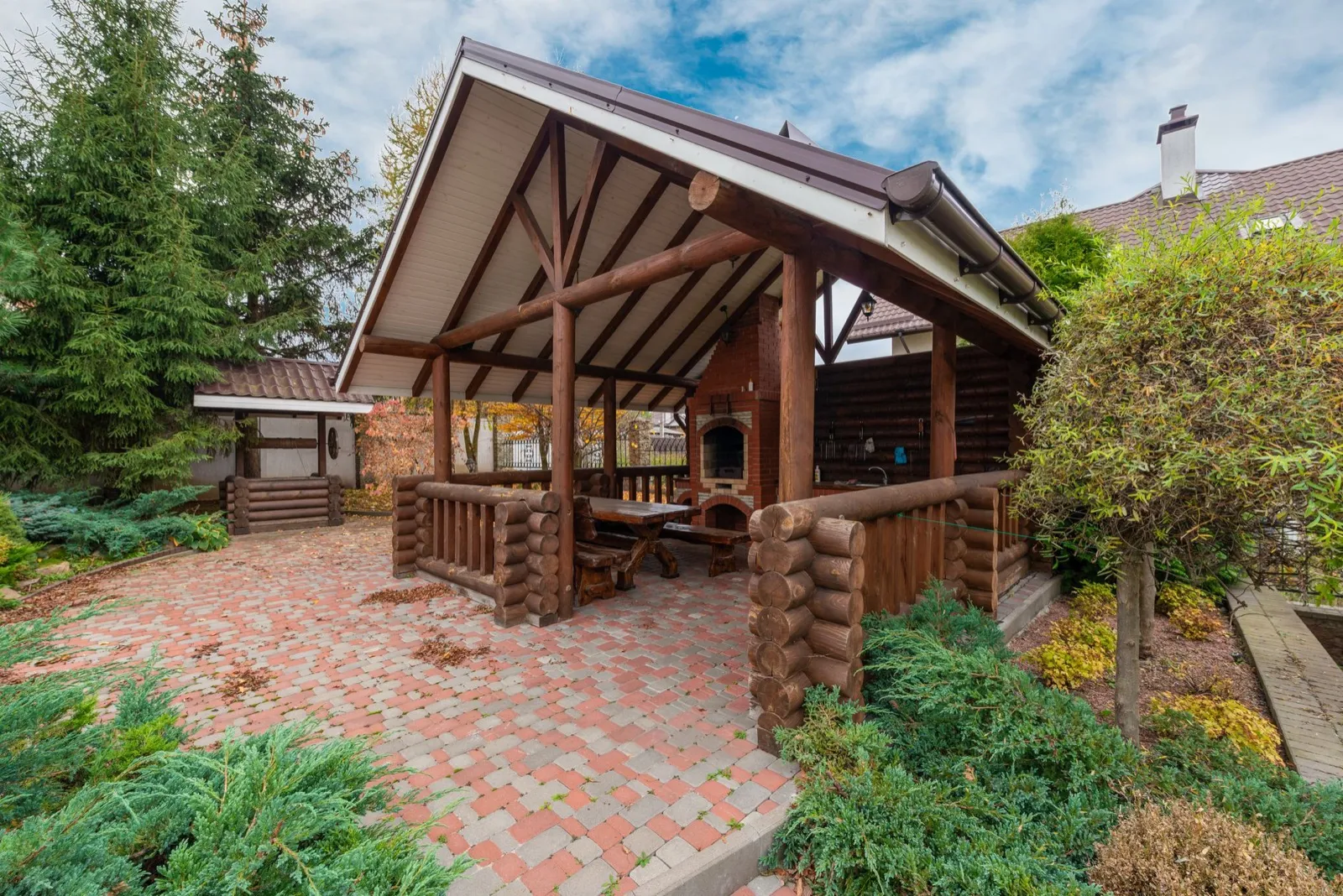 Covered outdoor living space with seating and an outdoor kitchen